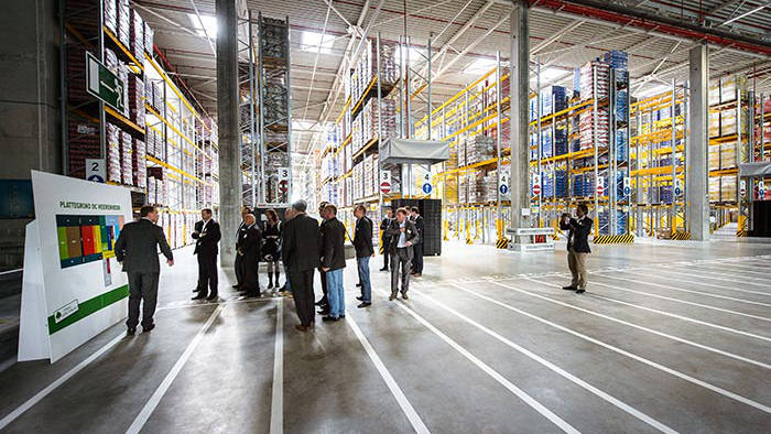 People attending a presentation in the Lidl Distribution Center warehouse lit by Philips Lighting